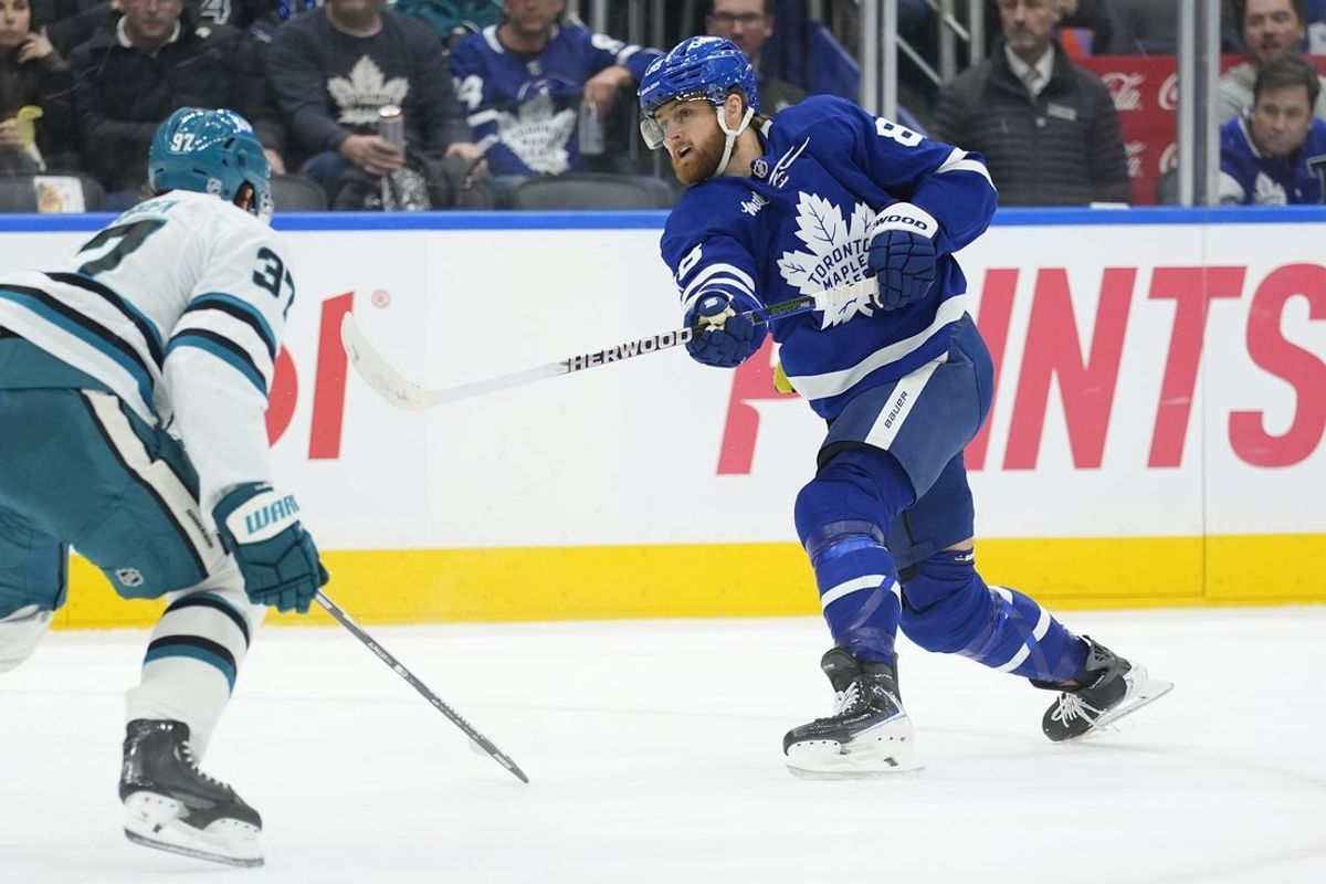 Dec 11, 2025; Toronto, Ontario, CAN; Toronto Maple Leafs forward William Nylander (88) shoots th epuck as San Jose Sharks defenseman Timothy Liljegren (37) defends during during the first period at Scotiabank Arena. Mandatory Credit: John E. Sokolowski-Imagn Images