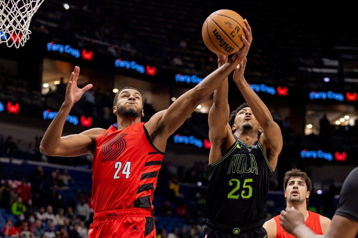 Dec 11, 2025; New Orleans, Louisiana, USA;  Portland Trail Blazers forward Kris Murray (24) grabs a rebound against New Orleans Pelicans forward Trey Murphy III (25) during the first half at Smoothie King Center. Mandatory Credit: Stephen Lew-Imagn Images