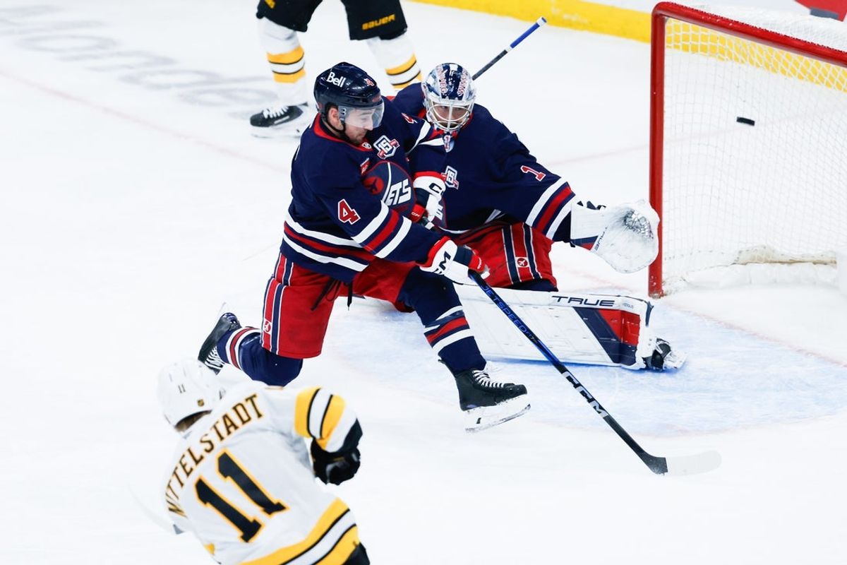 Dec 11, 2025; Winnipeg, Manitoba, CAN;  Boston Bruins forward Casey Mddlestadt (11) scores on Winnipeg Jets goalie Eric Comrie (1) during the first period at Canada Life Centre. Mandatory Credit: Terrence Lee-Imagn Images