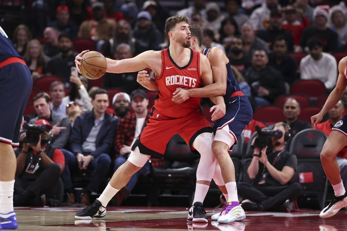 Dec 11, 2025; Houston, Texas, USA; Houston Rockets center Alperen Sengun (28) controls the ball as Los Angeles Clippers guard Bogdan Bogdanovic (10) defends during the second quarter at Toyota Center. Mandatory Credit: Troy Taormina-Imagn Images