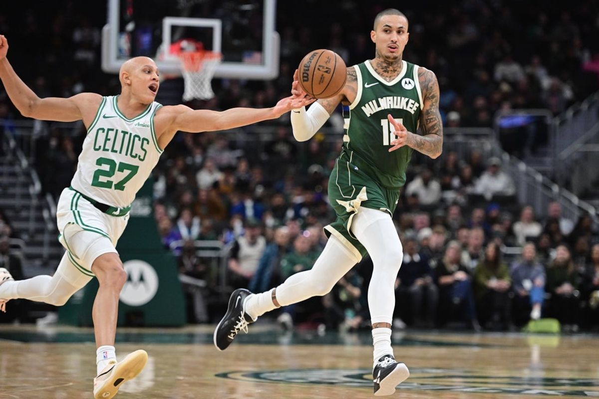Dec 11, 2025; Milwaukee, Wisconsin, USA; Boston Celtics forward Jordan Walsh (27) tries to steal the ball from Milwaukee Bucks forward Kyle Kuzma (18) in the second quarter at Fiserv Forum. Mandatory Credit: Benny Sieu-Imagn Images