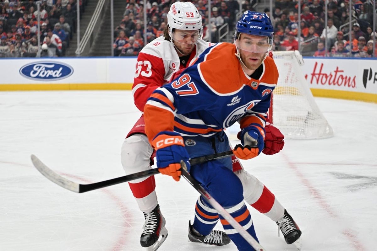Dec 11, 2025; Edmonton, Alberta, CAN; Detroit Red Wings defenseman Moritz Seider (53) and Edmonton Oilers center Connor McDavid (97) chase the puck during the first period at Rogers Place. Mandatory Credit: Walter Tychnowicz-Imagn Images