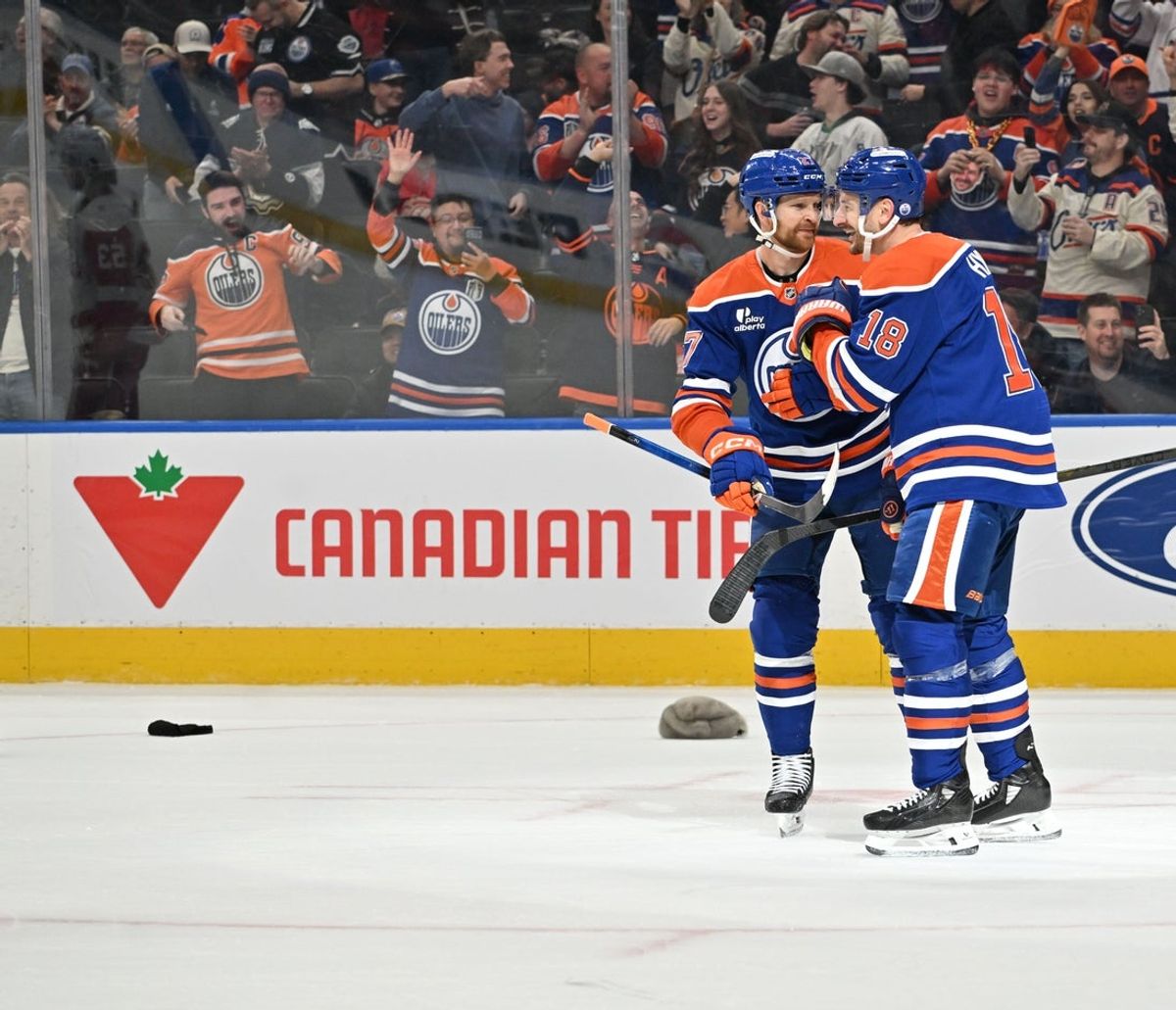 Dec 11, 2025; Edmonton, Alberta, CAN;  Oilers left winger Zach Hyman (18) and Oilers defenseman Brett Kulak (27) celebrate a goal against Detroit Red Wings goalie Cam Talbot (39) during the third period at Rogers Place. Mandatory Credit: Walter Tychnowicz-Imagn Images