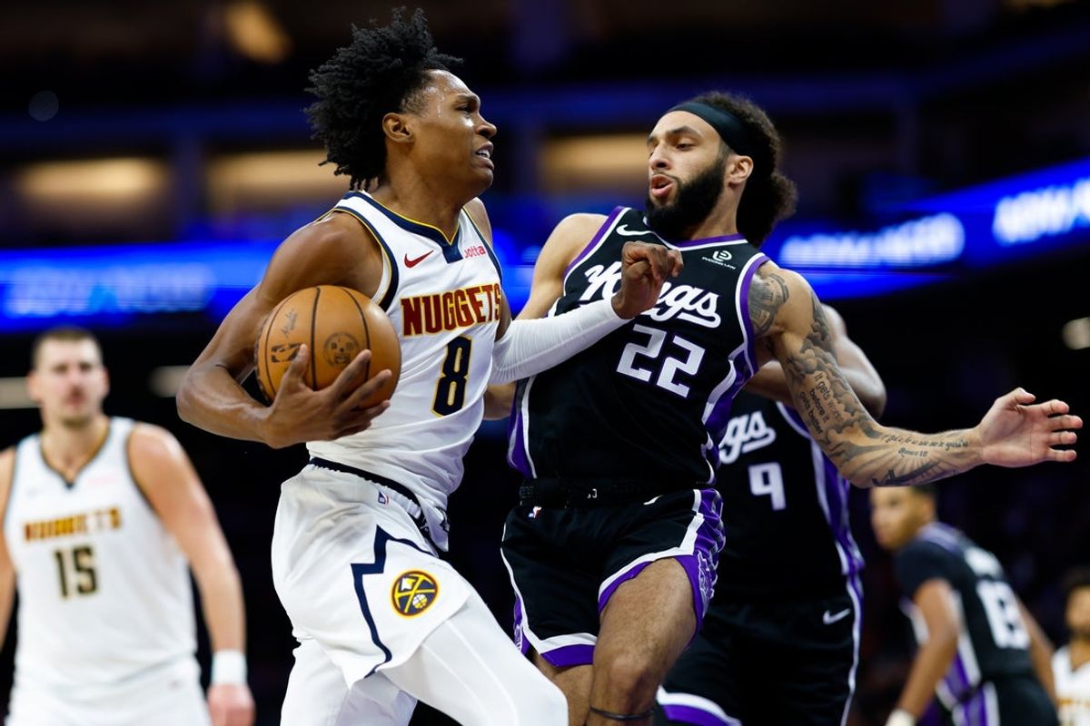 Dec 11, 2025; Sacramento, California, USA; Denver Nuggets guard Peyton Watson (8) drives to the basket against Sacramento Kings guard Devin Carter (22) during the third quarter at Golden 1 Center. Mandatory Credit: Sergio Estrada-Imagn Images