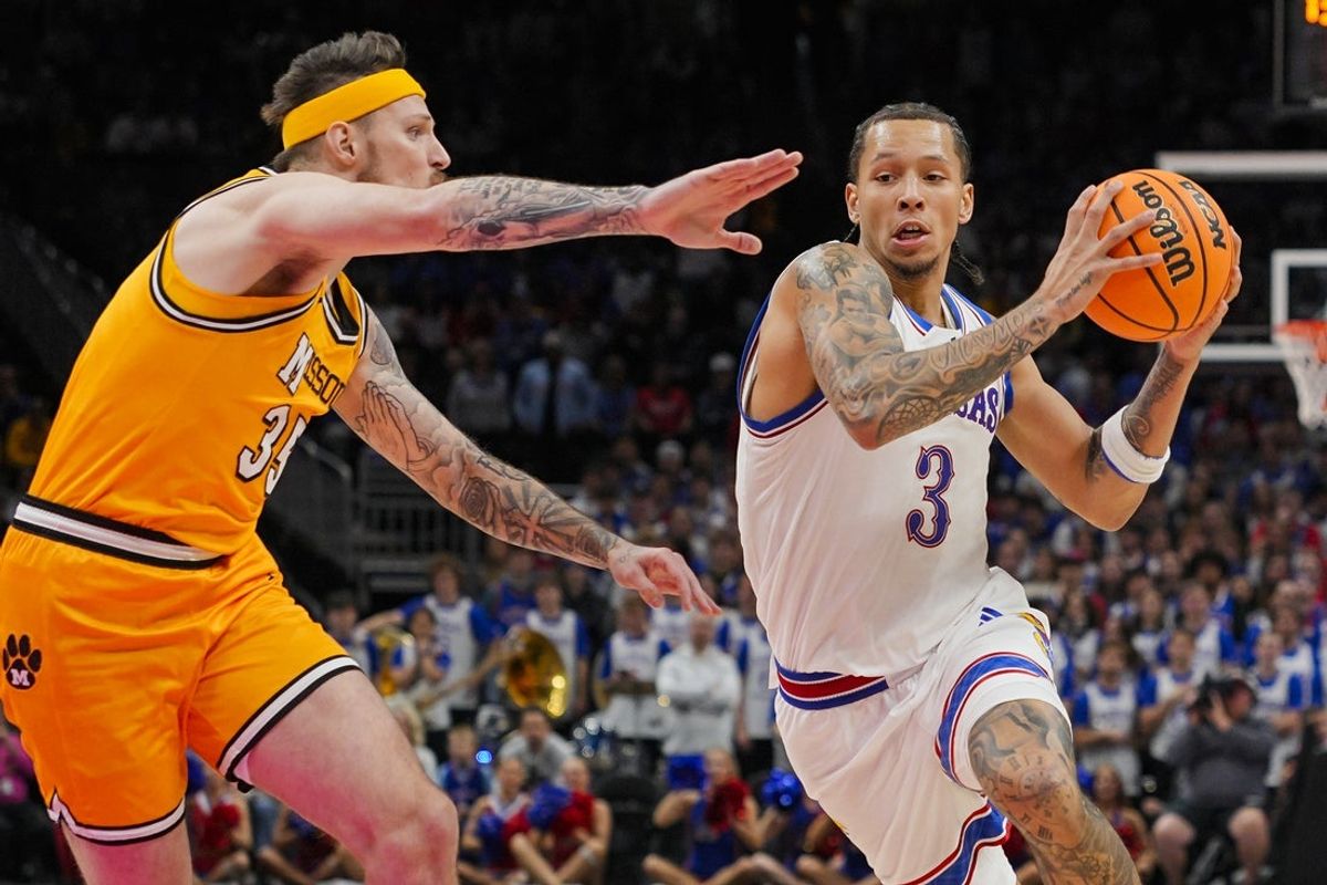 Dec 7, 2025; Kansas City, Missouri, USA; Kansas Jayhawks guard Tre White (3) drives against Missouri Tigers guard Jacob Crews (35) during the first half at T-Mobile Center. Mandatory Credit: Jay Biggerstaff-Imagn Images