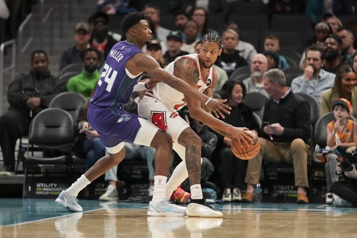 Dec 12, 2025; Charlotte, North Carolina, USA; Chicago Bulls forward Dalen Terry (7) handles the ball defended by Charlotte Hornets forward Brandon Miller (24) during the first quarter at Spectrum Center. Mandatory Credit: Jim Dedmon-Imagn Images