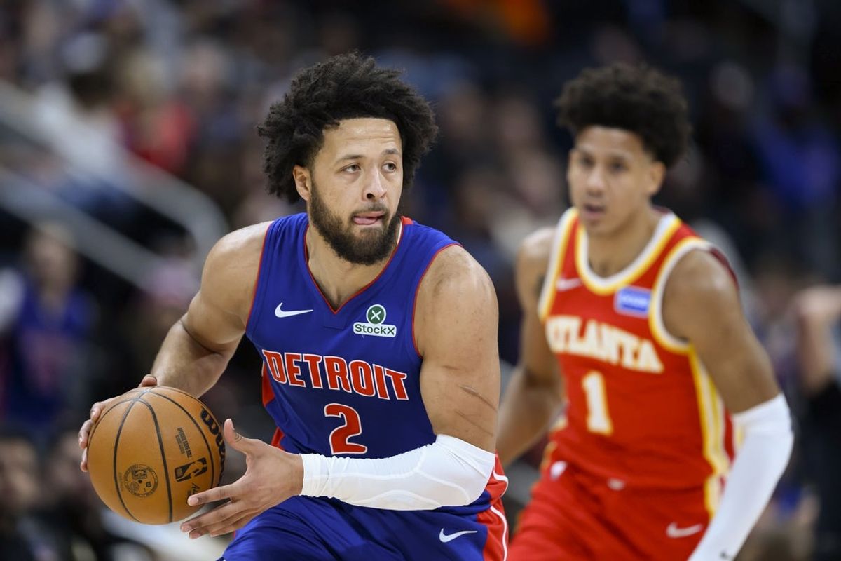 Dec 12, 2025; Detroit, Michigan, USA; Detroit Pistons guard Cade Cunningham (2) takes the ball up the court past Atlanta Hawks forward Jalen Johnson (1) in the first quarter at Little Caesars Arena. Mandatory Credit: Lon Horwedel-Imagn Images
