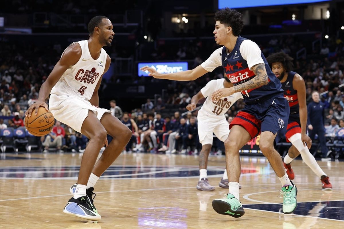 Dec 12, 2025; Washington, District of Columbia, USA; Cleveland Cavaliers forward Evan Mobley (4) dribbles the ball as Washington Wizards guard Will Riley (27) defends in the second half at Capital One Arena. Mandatory Credit: Geoff Burke-Imagn Images