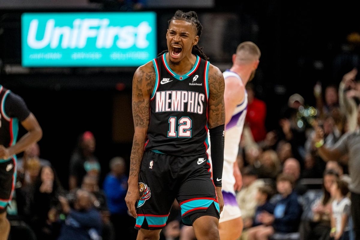 Dec 12, 2025; Memphis, Tennessee, USA; Memphis Grizzlies point guard Ja Morant (12) celebrates after making a three-pointer in the second half against the Utah Jazz at FedExForum. Mandatory Credit: Matthew Smith-Imagn Images
