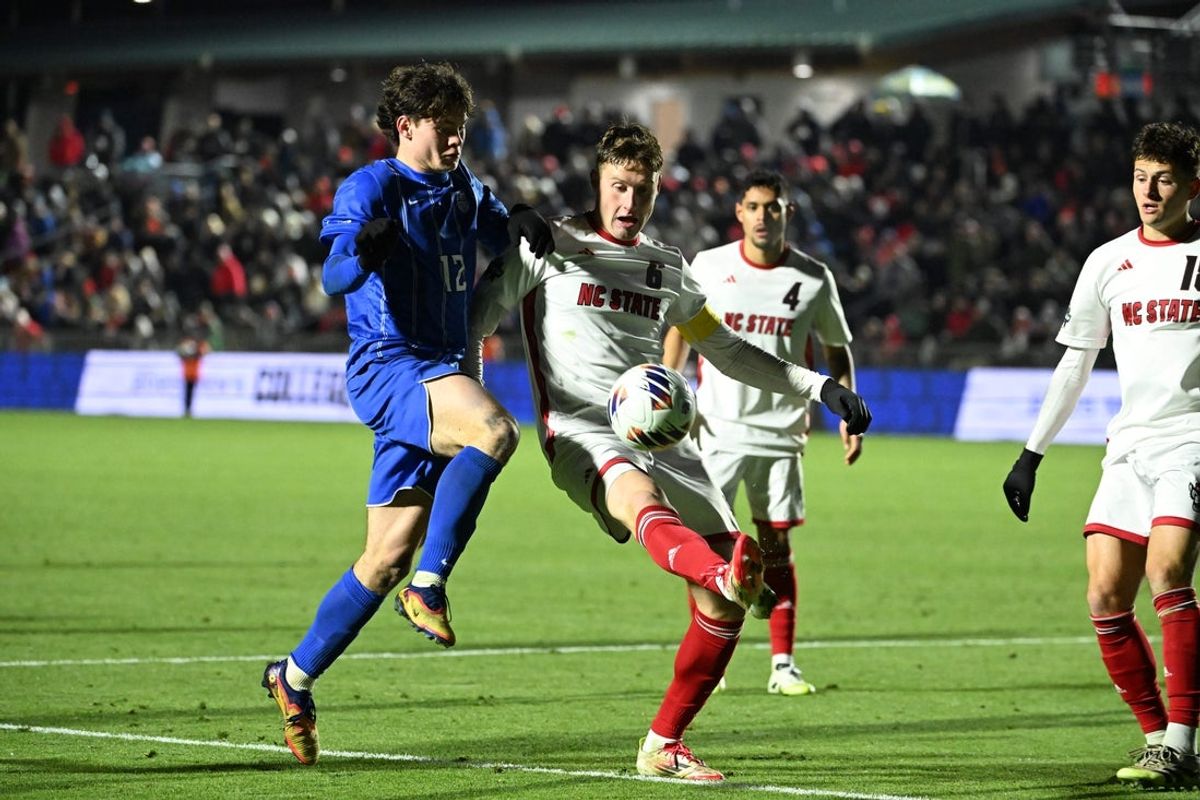 Dec 12, 2025; Cary, NC, USA; Saint Louis Billikens midfielder Jack Dimaria (12) and NC State Wolfpack defender Nikola Markovic (6) fight for the ball in the second half at First Horizon Stadium. Mandatory Credit: Bob Donnan-Imagn Images