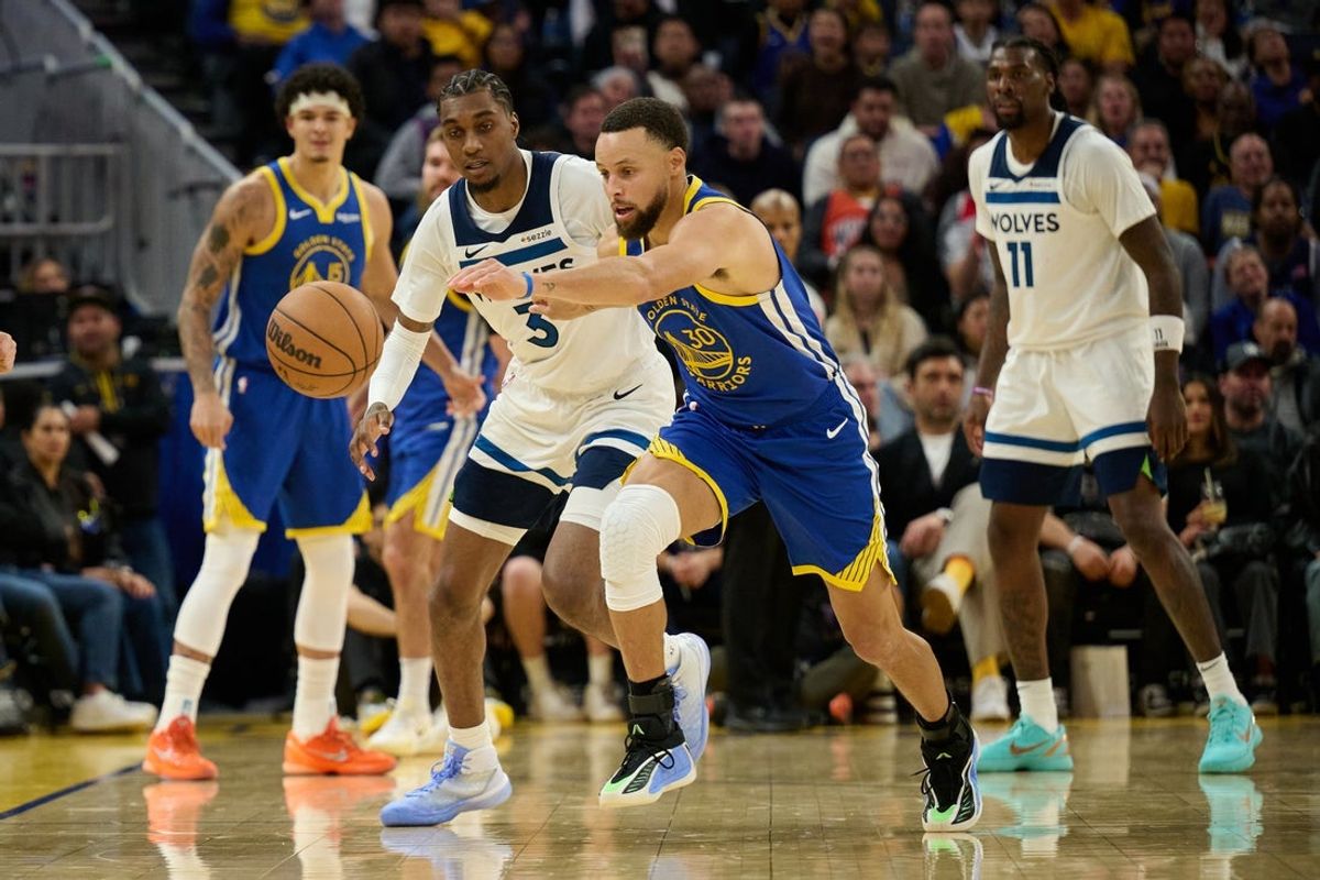 Dec 12, 2025; San Francisco, California, USA; Golden State Warriors guard Stephen Curry (30) extends for a loose ball against Minnesota Timberwolves forward Jaden McDaniels (3) and center Naz Reid (11) during the fourth quarter at Chase Center. Mandatory Credit: Robert Edwards-Imagn Images
