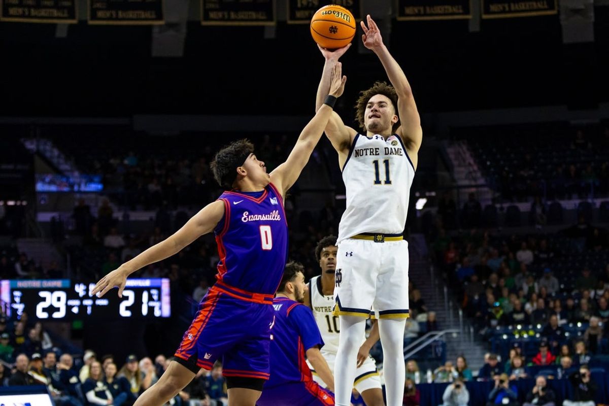Dec 13, 2025; South Bend, Indiana, USA; Notre Dame Fighting Irish guard Braeden Shrewsberry (11) shoots against Evansville Purple Aces guard Bryce Quinet (0) during the first half at Purcell Pavilion at the Joyce Center. Mandatory Credit: Michael Caterina-Imagn Images