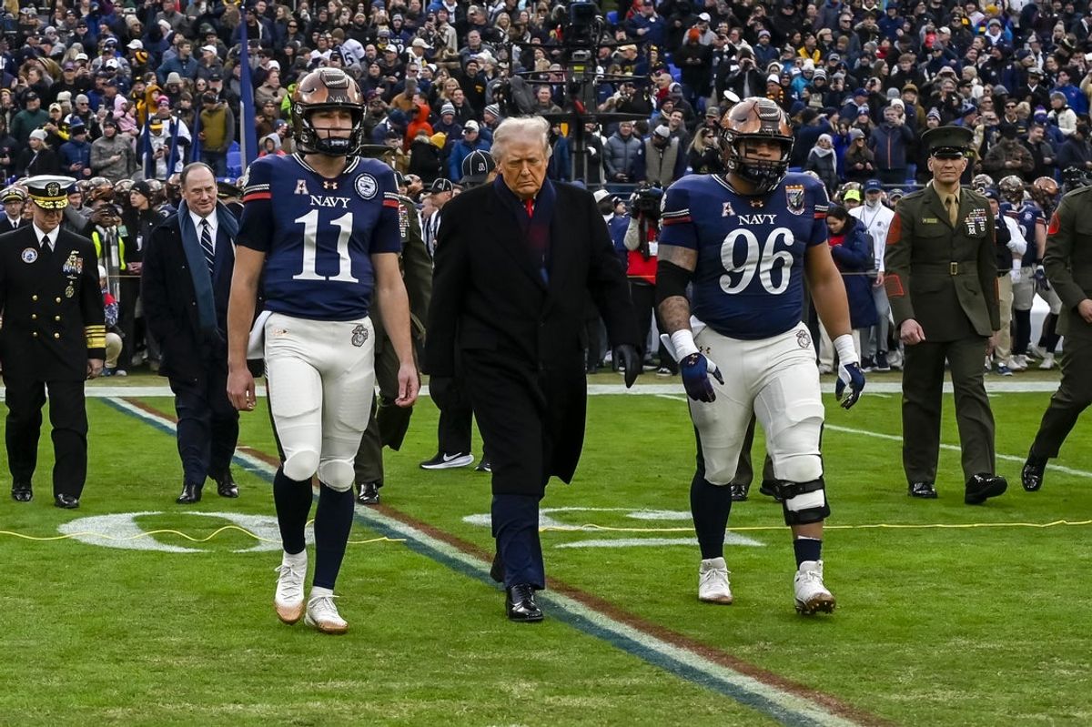 Dec 13, 2025; Baltimore, Maryland, USA;  Donald J Trump, President of the United States of America, walks on the field with Navy Midshipmen quarterback Blake Horvath (11) and Navy Midshipmen defensive lineman Landon Robinson (96)  before the game against the Army West Point Black Knights at M&T Bank Stadium. Mandatory Credit: Tommy Gilligan-Imagn Images