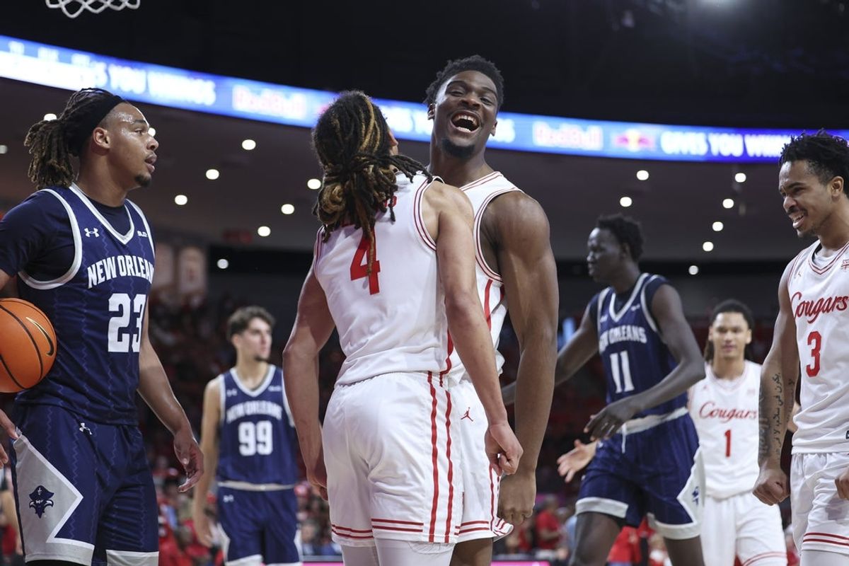 Dec 13, 2025; Houston, Texas, USA; Houston Cougars center Cedric Lath (8) celebrates with guard Kingston Flemings (4) after a play during the first half against the New Orleans Privateers at Fertitta Center. Mandatory Credit: Troy Taormina-Imagn Images