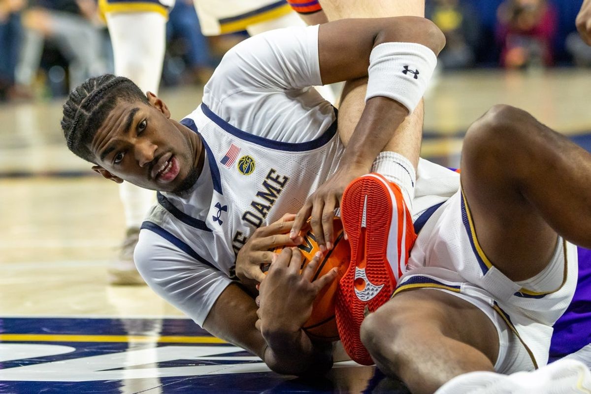 Dec 13, 2025; South Bend, Indiana, USA; Notre Dame Fighting Irish forward Kebba Njie (14) hands onto a loose ball against the Evansville Purple Aces during the second half at Purcell Pavilion at the Joyce Center. Mandatory Credit: Michael Caterina-Imagn Images