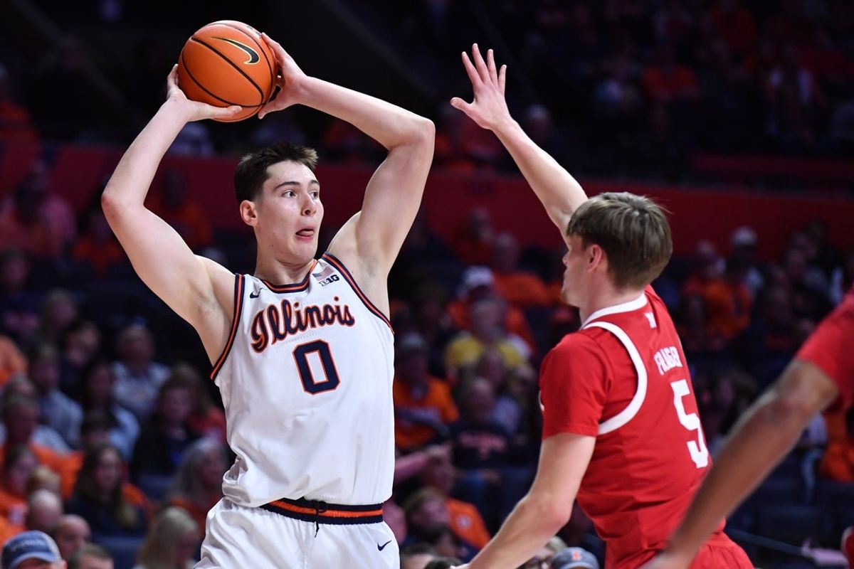 Dec 13, 2025; Champaign, Illinois, USA; Illinois Fighting Illini forward David Mirkovic (0) looks to pass as Nebraska Cornhuskers forward Braden Frager (5) defends during the first half at State Farm Center. Mandatory Credit: Ron Johnson-Imagn Images