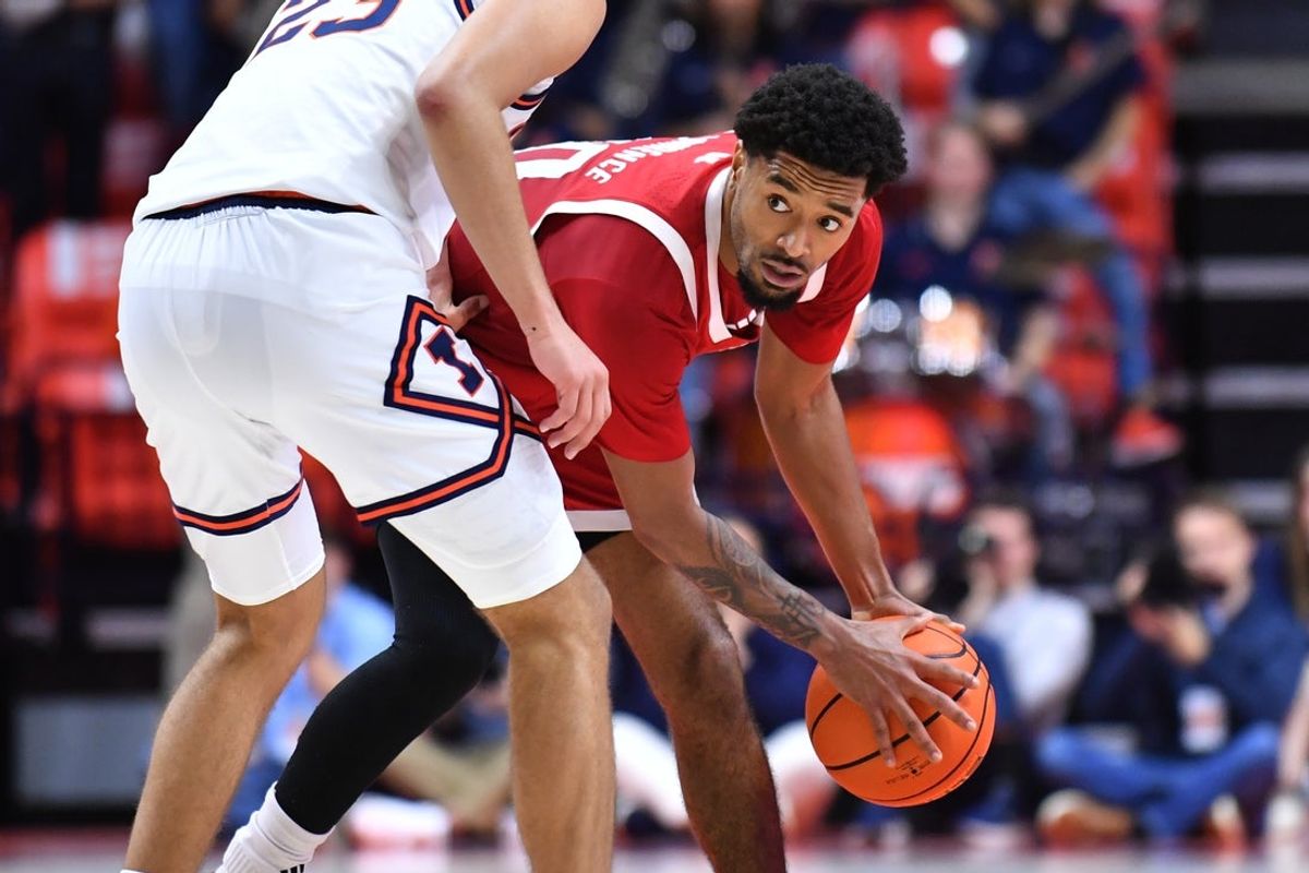 Dec 13, 2025; Champaign, Illinois, USA;  Nebraska Cornhuskers guard Jamarques Lawrence (10) looks around Illinois Fighting Illini guard Keaton Wagler (23) during the second half at State Farm Center. Mandatory Credit: Ron Johnson-Imagn Images