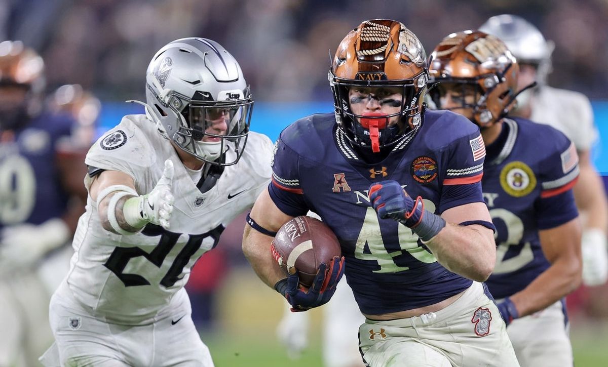 Dec 13, 2025; Baltimore, Maryland, USA; Navy Midshipmen slotback Justin Brown (46) runs the ball against the Army Black Knights during the second half of the 126th Army-Navy game at M&T Bank Stadium. Mandatory Credit: Danny Wild-Imagn Images