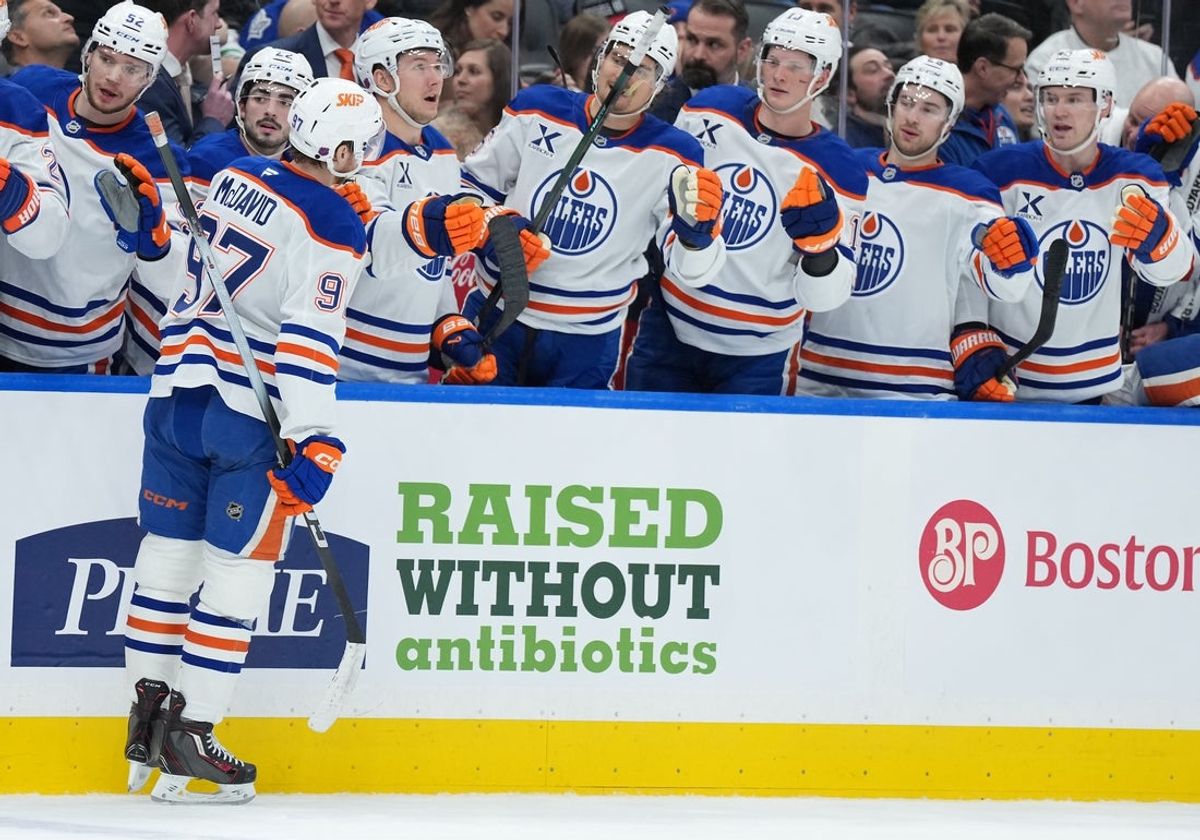 Dec 13, 2025; Toronto, Ontario, CAN; Edmonton Oilers center Connor McDavid (97) celebrates at the bench after scoring a goal against the Toronto Maple Leafs during the second period at Scotiabank Arena. Mandatory Credit: Nick Turchiaro-Imagn Images