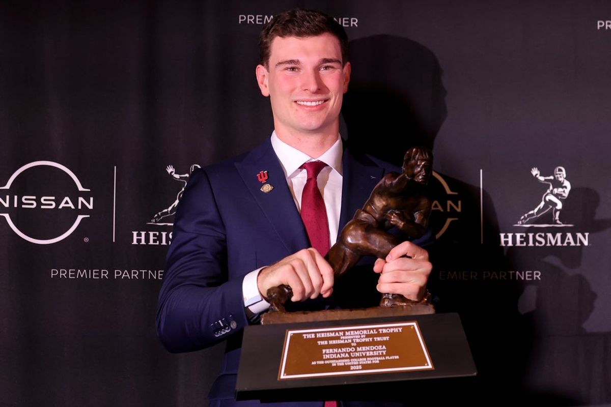 Dec 13, 2025; New York, NY, USA; Indiana Hoosiers quarterback Fernando Mendoza poses for photos with the Heisman trophy during a press conference at the New York Marriott Marquis after winning the award. Mandatory Credit: Brad Penner-Imagn Images