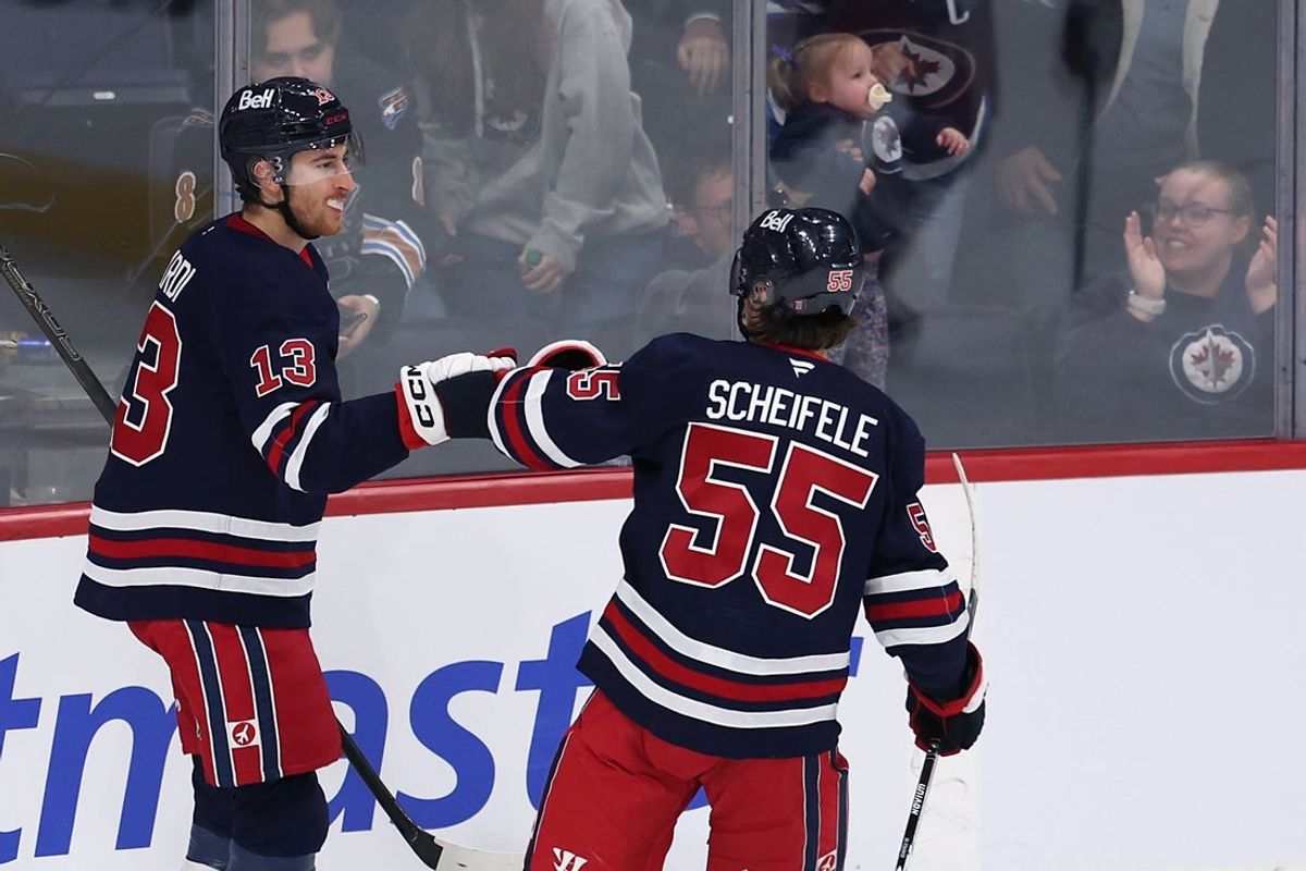 Dec 13, 2025; Winnipeg, Manitoba, CAN; Winnipeg Jets center Gabriel Vilardi (13) celebrates a goal against the Washington Capitals with Winnipeg Jets center Mark Scheifele (55) in the third period at Canada Life Centre. Mandatory Credit: James Carey Lauder-Imagn Images