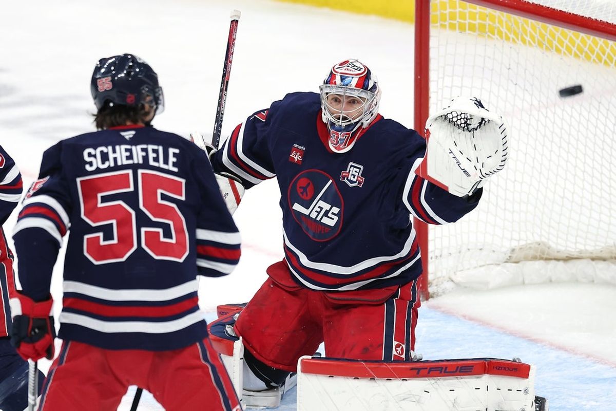 Dec 13, 2025; Winnipeg, Manitoba, CAN; Winnipeg Jets center Mark Scheifele (55) watches a puck go wide of goaltender Connor Hellebuyck (37) in a game against the Washington Capitals in the third period at Canada Life Centre. Mandatory Credit: James Carey Lauder-Imagn Images