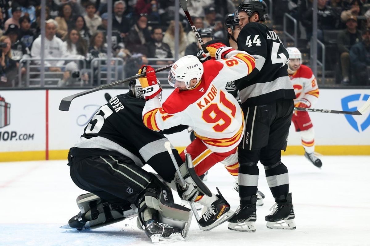 Dec 13, 2025; Los Angeles, California, USA;  Calgary Flames center Nazem Kadri (91) collides with Los Angeles Kings goaltender Darcy Kuemper (35) during the first period at Crypto.com Arena. Mandatory Credit: Kiyoshi Mio-Imagn Images