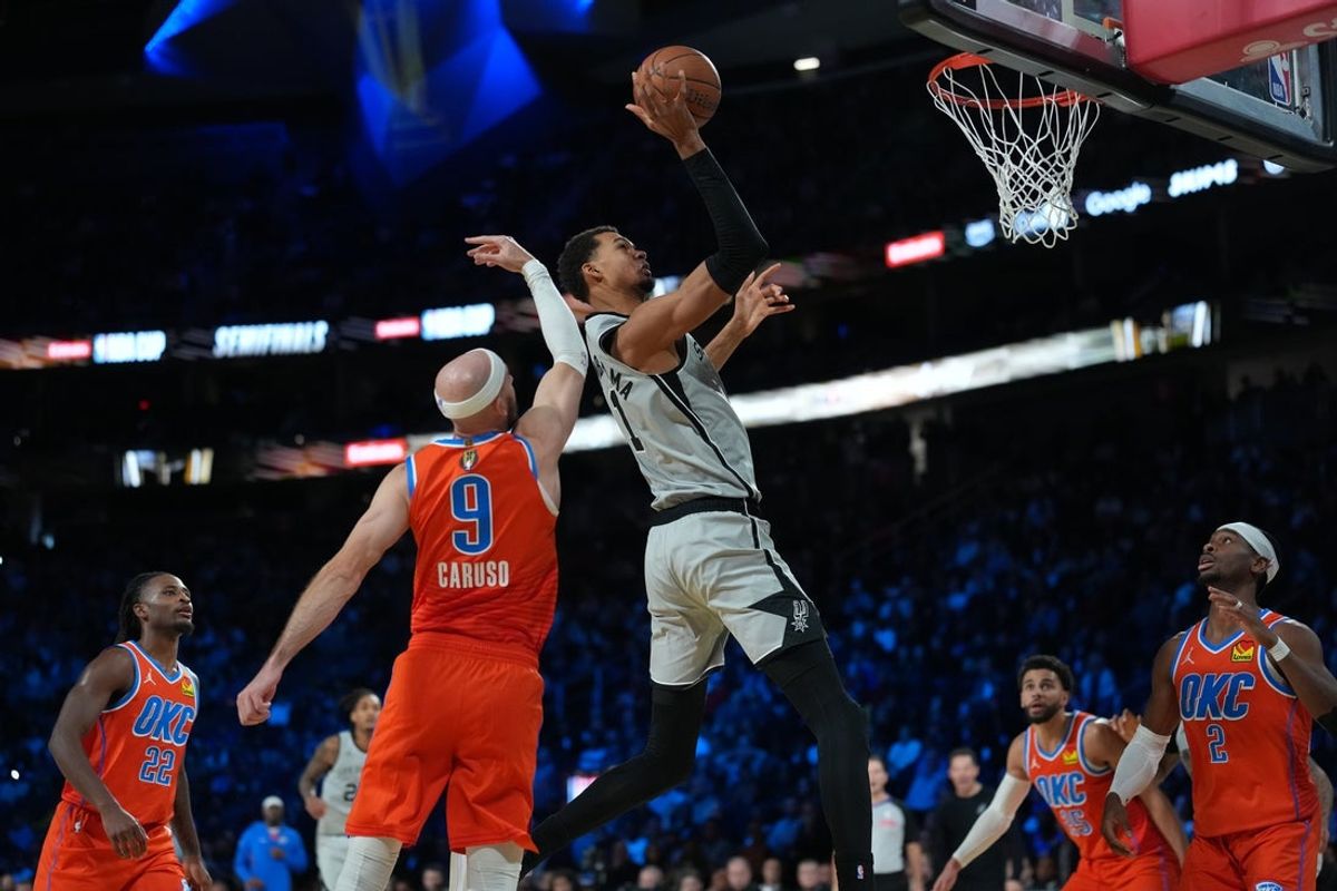 Dec 13, 2025; Las Vegas, Nevada, USA; San Antonio Spurs forward Victor Wembanyama (1) goes to the basket as Oklahoma City Thunder guard Alex Caruso (9) defends during the fourth quarter at T-Mobile Arena. Mandatory Credit: Kirby Lee-Imagn Images