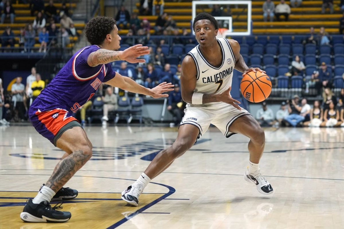 Dec 13, 2025; Berkeley, California, USA; California Golden Bears guard Dai Dai Ames (7) handles the ball against Northwestern State Demons guard Izzy Miles (left) during the first half at Haas Pavilion. Mandatory Credit: Darren Yamashita-Imagn Images