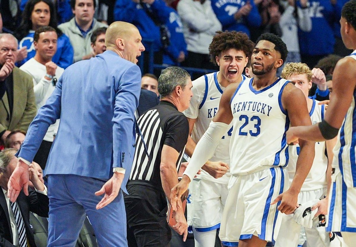Kentucky Wildcats head coach Mark Pope reacts to Kentucky Wildcats forward Mouhamed Dioubate (23) after he helped spark the Cats' win over Indiana in the second half during Saturday's college basketball game at Rupp Arena in Lexington, Kentucky December 13, 2025.