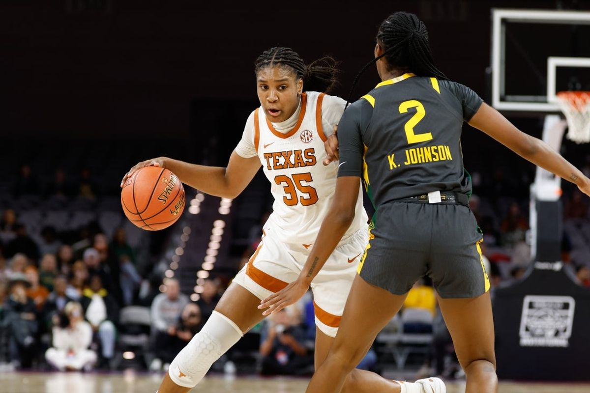 Dec 14, 2025; Fort Worth, Texas, USA; Texas Longhorns forward Madison Booker (35) drives to the basket against Baylor Bears forward Kiersten Johnson (2) during the first half at Dickies Arena. Mandatory Credit: Chris Jones-Imagn Images
