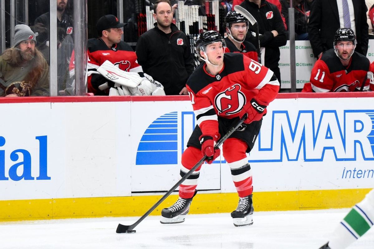 Dec 14, 2025; Newark, New Jersey, USA; New Jersey Devils center Dawson Mercer (91) controls the puck against the Vancouver Canucks during the second period at Prudential Center. Mandatory Credit: John Jones-Imagn Images