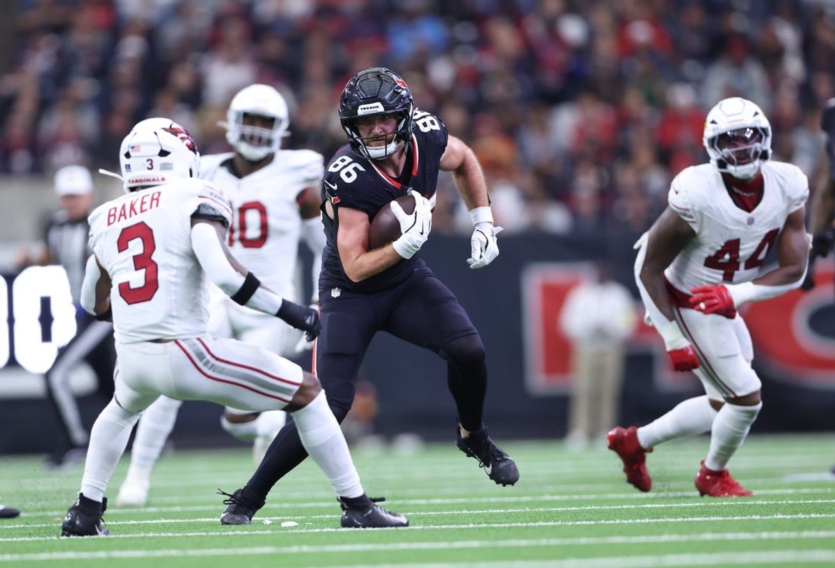 Dec 14, 2025; Houston, Texas, USA; Houston Texans tight end Dalton Schultz (86) runs for a gain past Arizona Cardinals safety Budda Baker (3) during the second quarter at NRG Stadium. Mandatory Credit: Troy Taormina-Imagn Images
