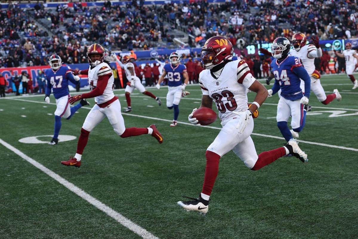Dec 14, 2025; East Rutherford, New Jersey, USA;  Washington Commanders wide receiver Jaylin Lane (83) runs the ball for a punt return touchdown during the second quarter against the New York Giants at MetLife Stadium. Mandatory Credit: Vincent Carchietta-Imagn Images