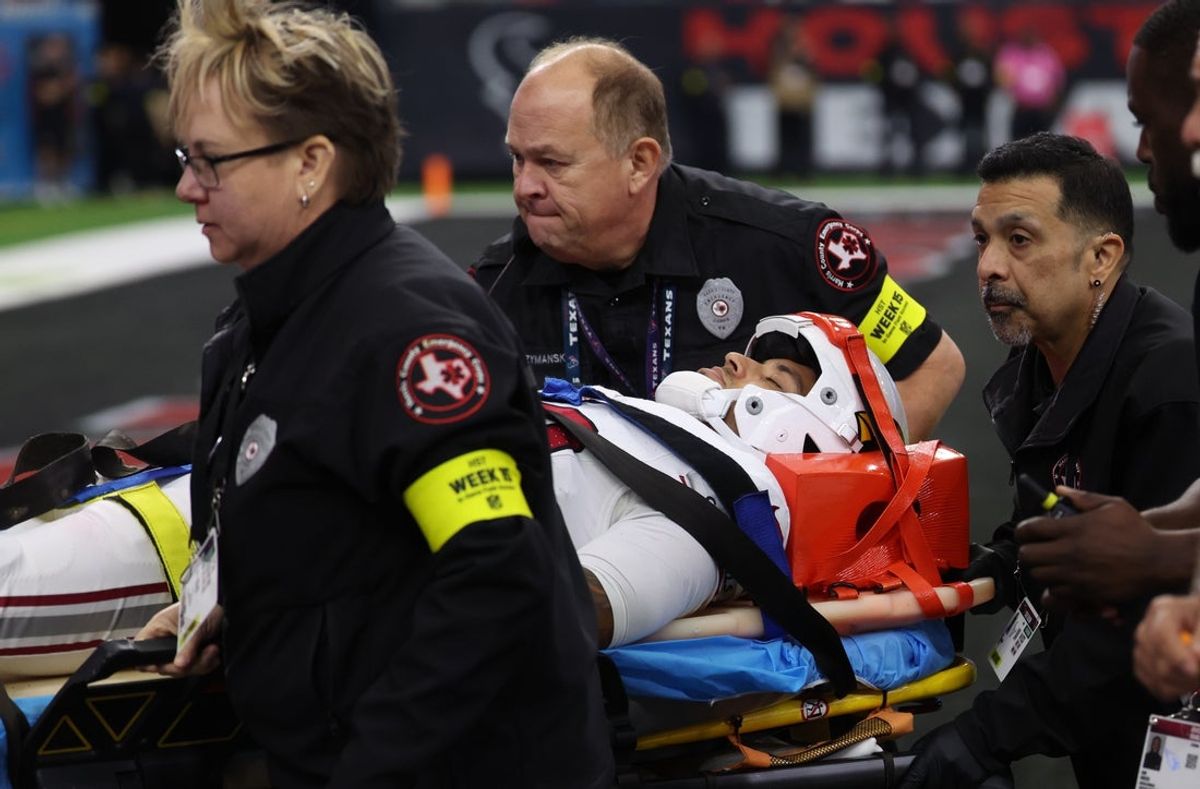 Dec 14, 2025; Houston, Texas, USA; Medical personnel treat Arizona Cardinals wide receiver Andre Baccellia (82) following an injury on a kickoff return during the second quarter against the Houston Texans at NRG Stadium. Mandatory Credit: Thomas Shea-Imagn Images