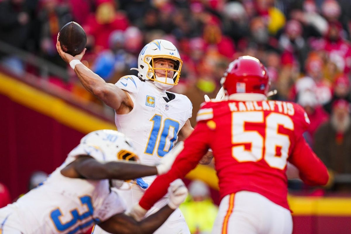 Dec 14, 2025; Kansas City, Missouri, USA; Los Angeles Chargers quarterback Justin Herbert (10) passes against the Kansas City Chiefs during the fourth quarter at GEHA Field at Arrowhead Stadium. Mandatory Credit: Jay Biggerstaff-Imagn Images
