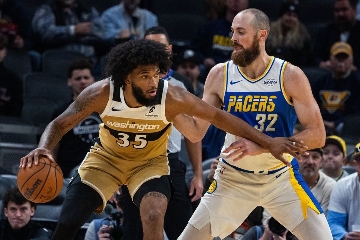 Dec 14, 2025; Indianapolis, Indiana, USA;  Washington Wizards forward Marvin Bagley III (35) dribbles the ball while Indiana Pacers center Jay Huff (32) defends in the first half at Gainbridge Fieldhouse. Mandatory Credit: Trevor Ruszkowski-Imagn Images