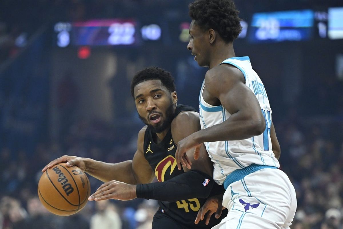 Dec 14, 2025; Cleveland, Ohio, USA; Cleveland Cavaliers guard Donovan Mitchell (45) dribbles beside Charlotte Hornets forward Moussa Diabate (14) in the first quarter at Rocket Arena. Mandatory Credit: David Richard-Imagn Images