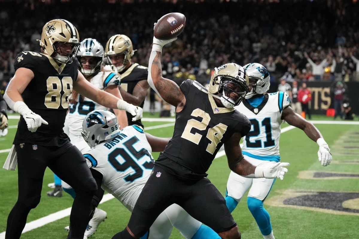Dec 14, 2025; New Orleans, Louisiana, USA; New Orleans Saints running back Devin Neal (24) reacts after scoring a touchdown during the second quarter against the Carolina Panthers at Caesars Superdome. Mandatory Credit: Matthew Hinton-Imagn Images