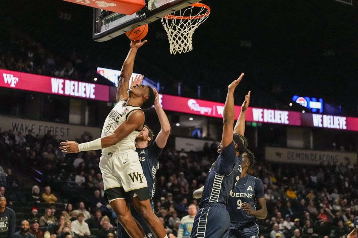 Dec 14, 2025; Winston-Salem, North Carolina, USA;  Wake Forest Demon Deacons guard Myles Colvin (6) with a fast break lay up against the Queens University Royals during the first half at Lawrence Joel Veterans Memorial Coliseum. Mandatory Credit: Jim Dedmon-Imagn Images
