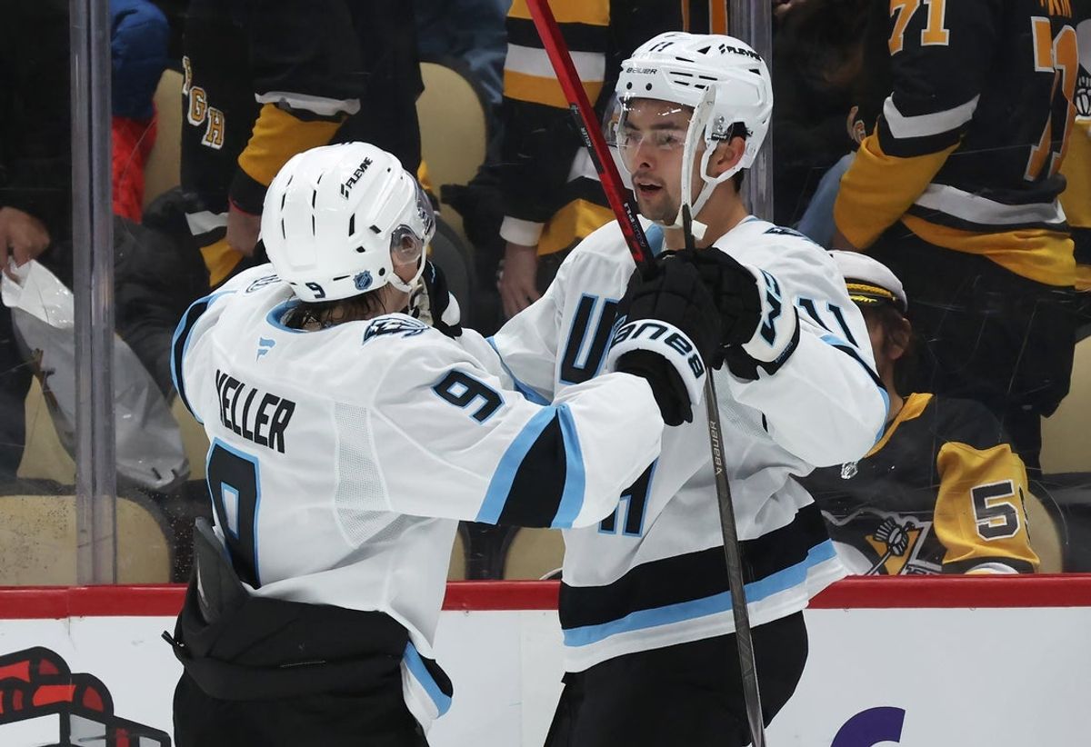 Dec 14, 2025; Pittsburgh, Pennsylvania, USA;  Utah Mammoth right wing Clayton Keller (9) congratulates right wing Dylan Guenther (11) on his game winning goal in overtime to defeat the Pittsburgh Penguins at PPG Paints Arena. Mandatory Credit: Charles LeClaire-Imagn Images