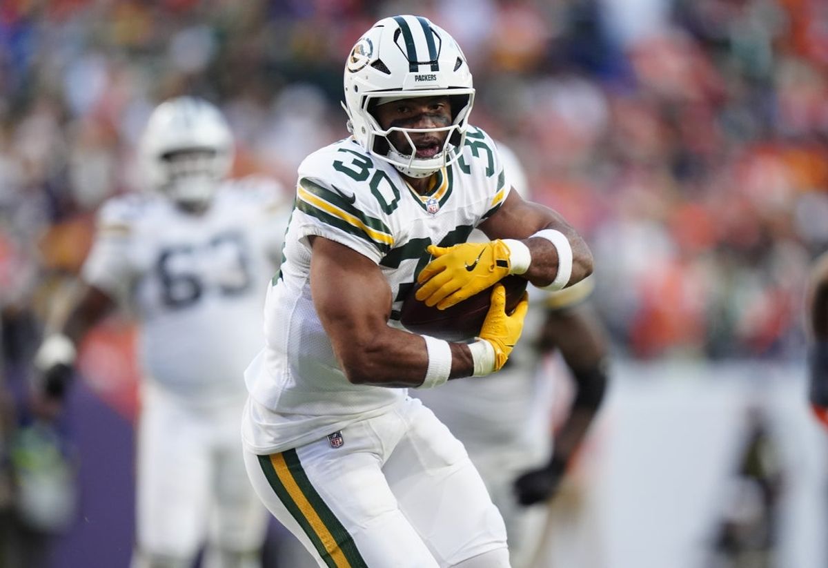 Dec 14, 2025; Denver, Colorado, USA; Green Bay Packers running back Chris Brooks (30) runs for a gain during the third quarter against the Denver Broncos at Empower Field at Mile High. Mandatory Credit: Ron Chenoy-Imagn Images