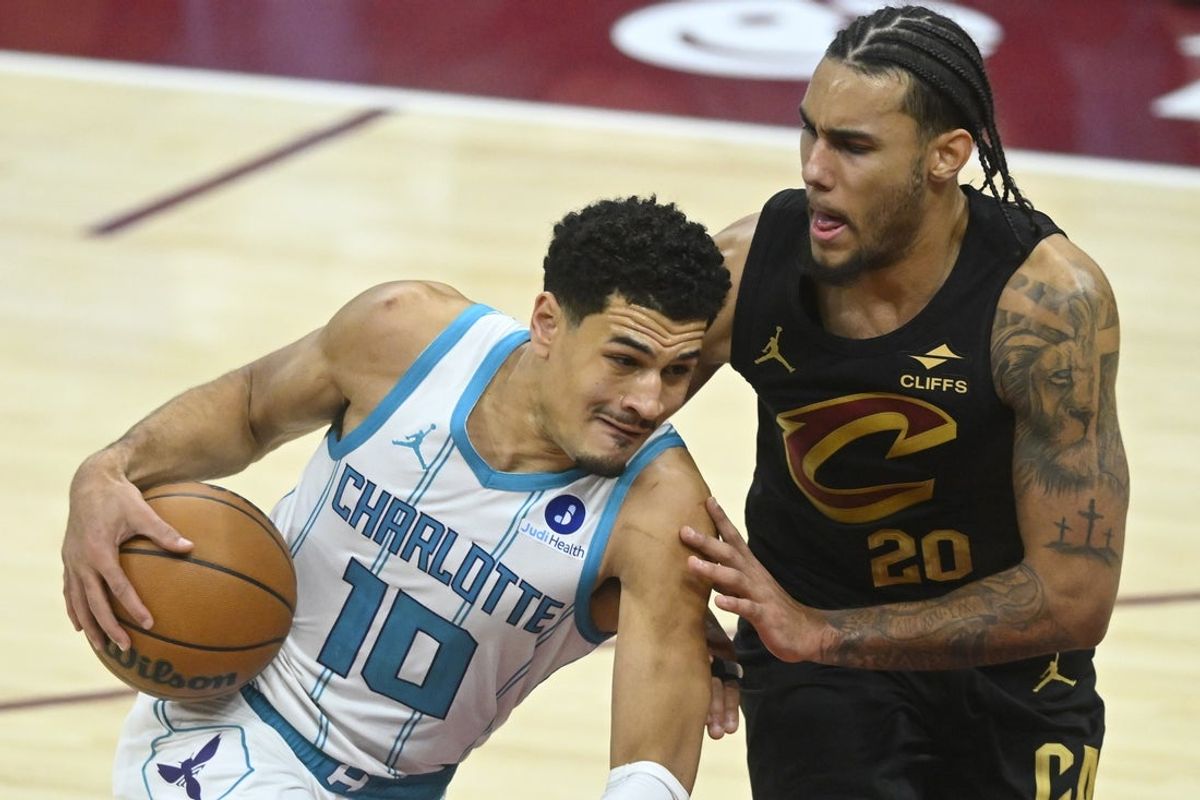 Dec 14, 2025; Cleveland, Ohio, USA; Charlotte Hornets guard Josh Green (10) dribbles beside Cleveland Cavaliers guard Jaylon Tyson (20) in the fourth quarter at Rocket Arena. Mandatory Credit: David Richard-Imagn Images