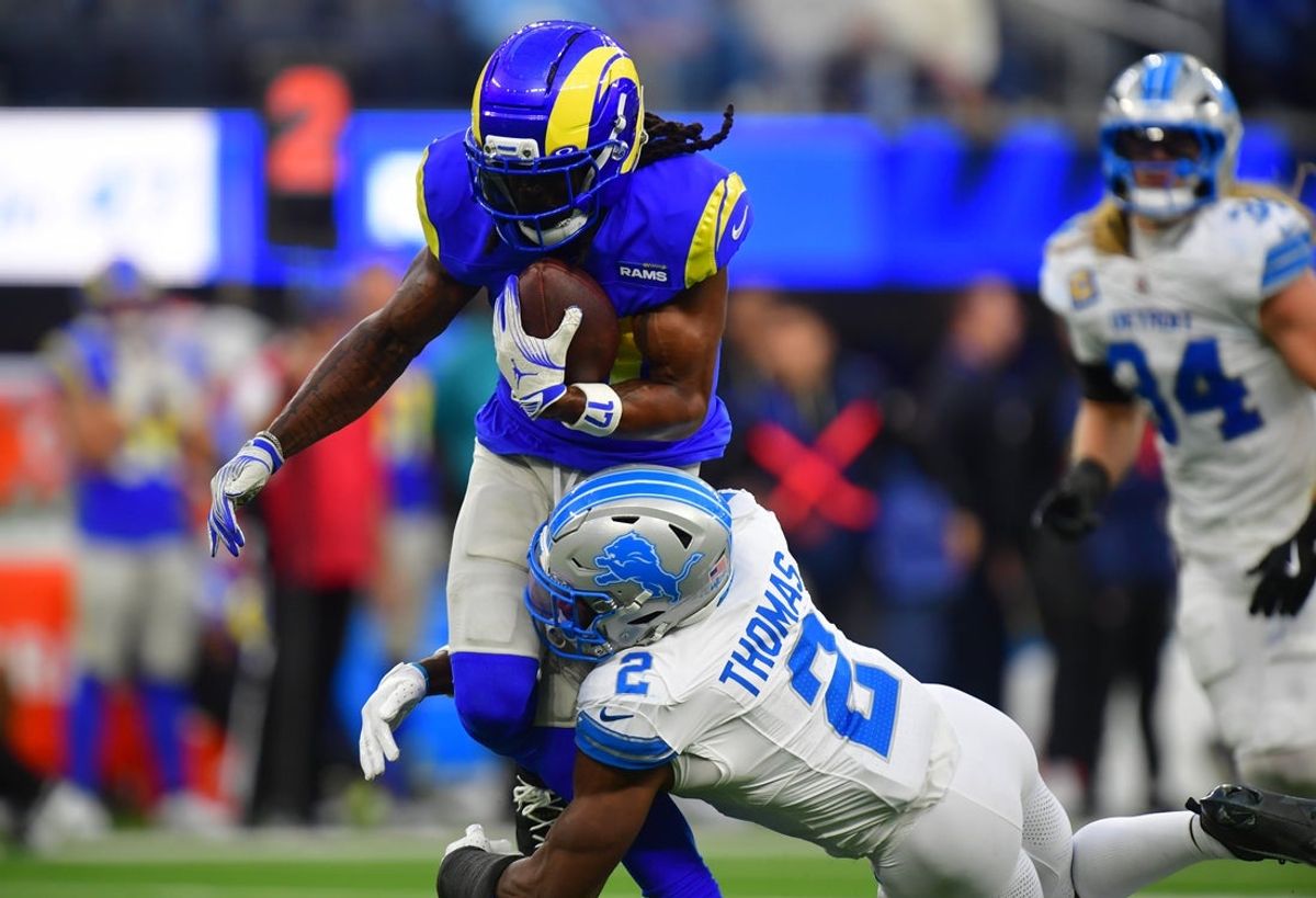 Dec 14, 2025; Inglewood, California, USA; Los Angeles Rams wide receiver Davante Adams (17) runs after a catch against Detroit Lions safety Daniel Thomas (2) during the third quarter at SoFi Stadium. Mandatory Credit: Gary A. Vasquez-Imagn Images