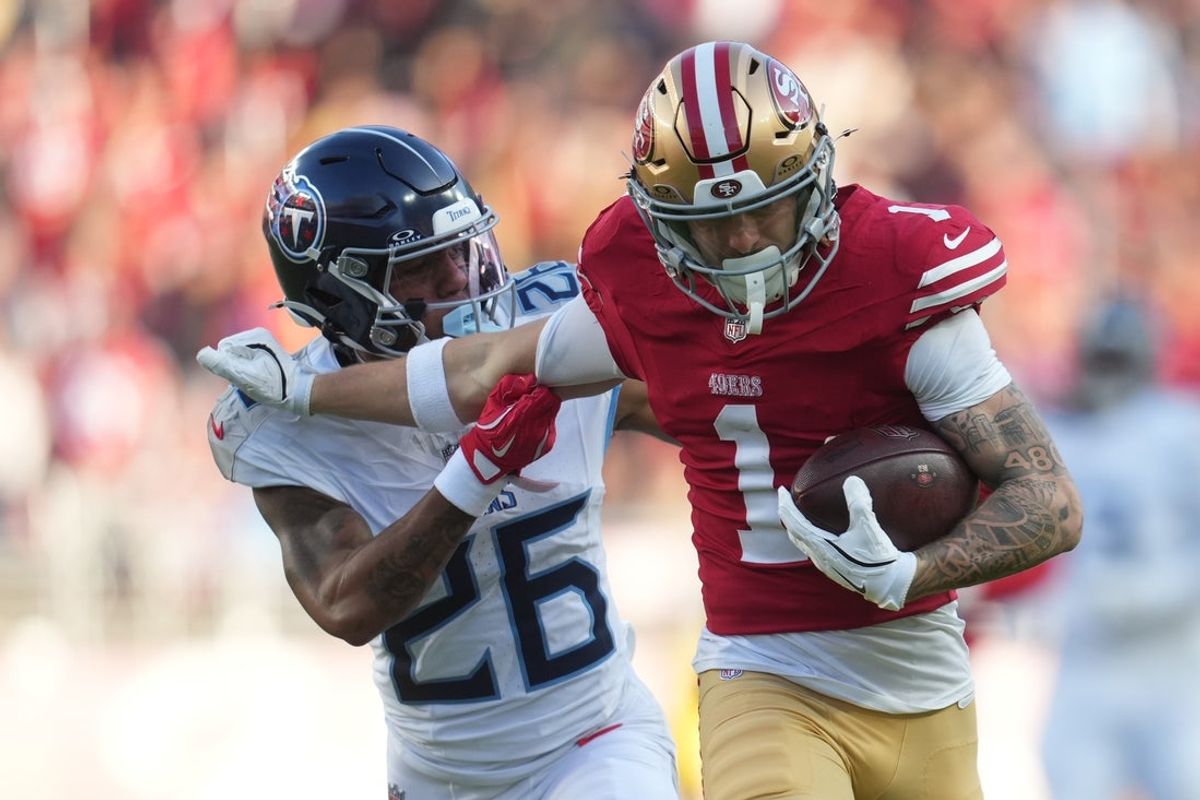 Dec 14, 2025; Santa Clara, California, USA;  San Francisco 49ers wide receiver Ricky Pearsall (1) stiff arms Tennessee Titans cornerback Marcus Harris (26) during the third quarter at Levi's Stadium. Mandatory Credit: Cary Edmondson-Imagn Images