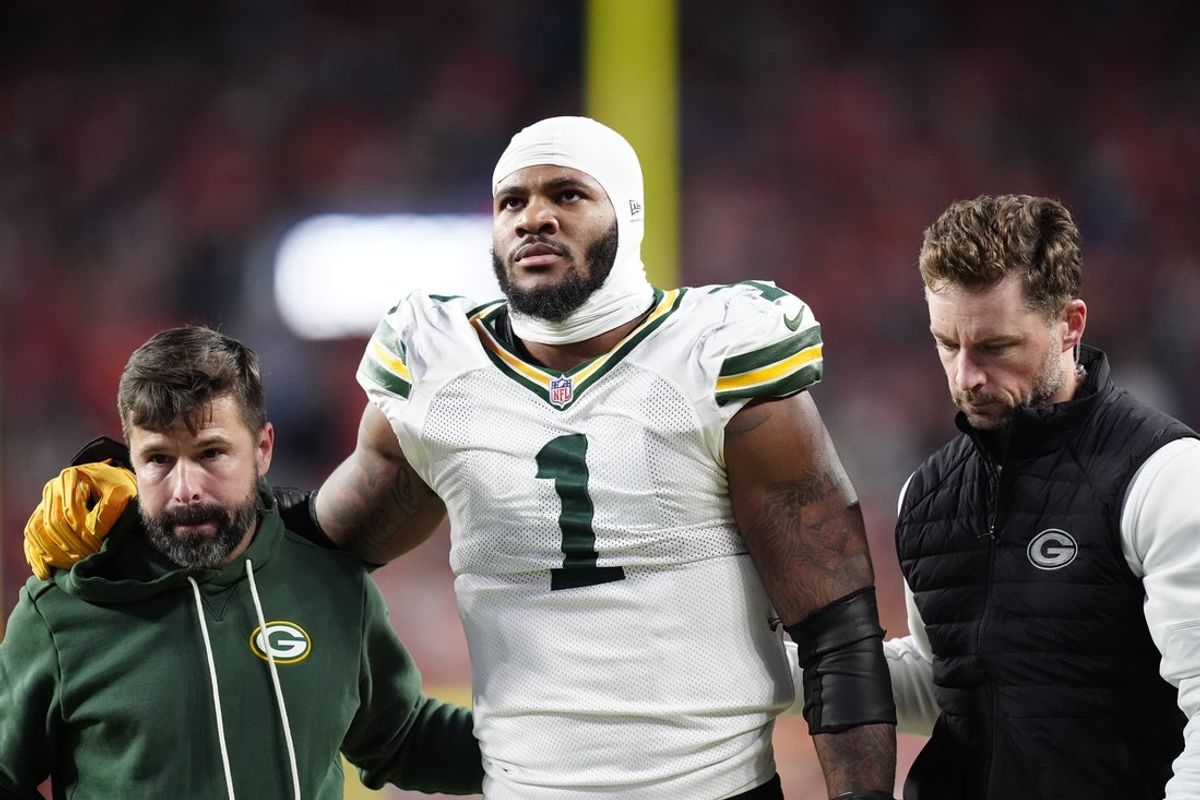 Dec 14, 2025; Denver, Colorado, USA; Green Bay Packers defensive end Micah Parsons (1) walks off the field with help from medical personnel following an injury during the third quarter against the Denver Broncos at Empower Field at Mile High. Mandatory Credit: Ron Chenoy-Imagn Images