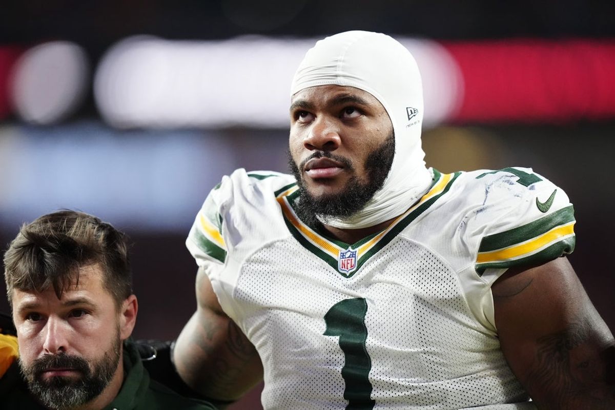 Dec 14, 2025; Denver, Colorado, USA; Green Bay Packers defensive end Micah Parsons (1) walks off the field with help from medical personnel following an injury during the third quarter against the Denver Broncos at Empower Field at Mile High. Mandatory Credit: Ron Chenoy-Imagn Images