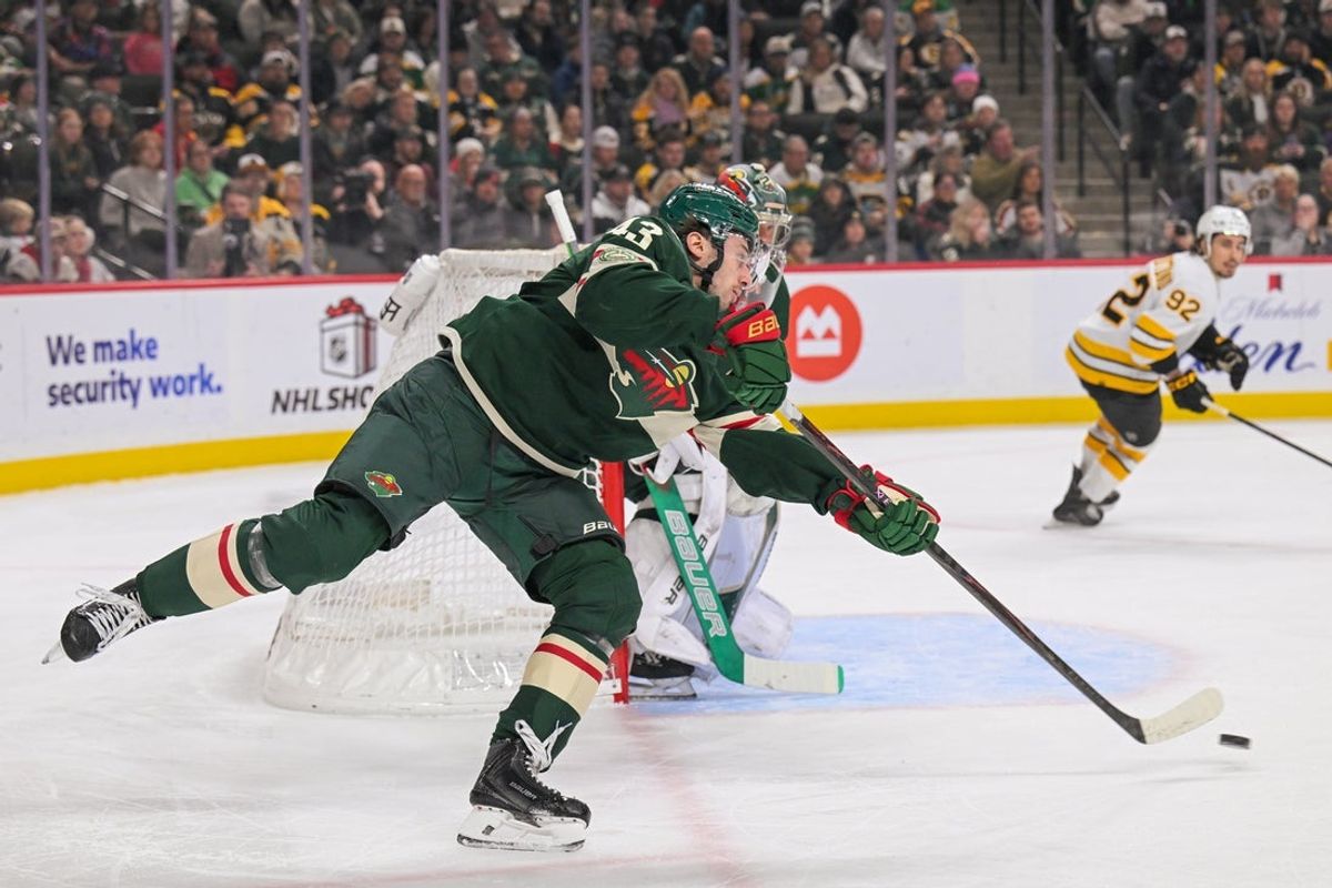 Dec 14, 2025; Saint Paul, Minnesota, USA;  Minnesota Wild defensemen Quinn Hughes (43) makes a pass against the Boston Bruins during the first period at Grand Casino Arena. Mandatory Credit: Nick Wosika-Imagn Images
