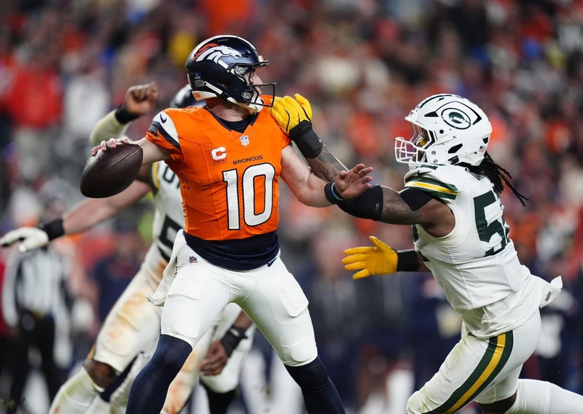 Dec 14, 2025; Denver, Colorado, USA; Denver Broncos quarterback Bo Nix (10) attempts to throw downfield under pressure from Green Bay Packers defensive end Rashan Gary (52) during the fourth quarter at Empower Field at Mile High. Mandatory Credit: Ron Chenoy-Imagn Images