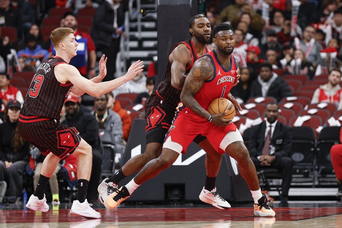 Dec 14, 2025; Chicago, Illinois, USA; Chicago Bulls forward Patrick Williams (44) defends against New Orleans Pelicans forward Zion Williamson (1) during the first half at United Center. Mandatory Credit: Kamil Krzaczynski-Imagn Images